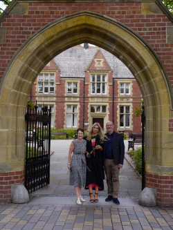 Millie with her parents under that archway.